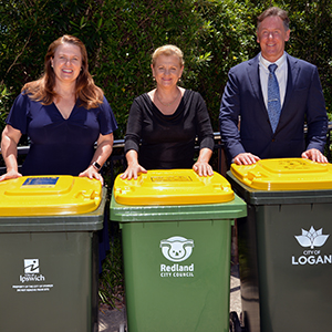 An image of Waste Alliance partners (from left) Mayor Teresa Harding (Ipswich), Mayor Karen Williams (Redland) and Mayor Darren Power (Logan) standing with waste recycling bins.