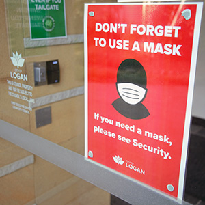An image showing a sign on the front door at Council advising masks must be worn .