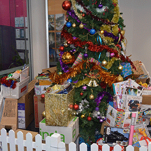 Christmas tree with gifts and food that has been donated