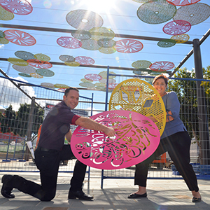 An image of Economic Development Chair Deputy Mayor Jon Raven and Division 12 Councillor Karen Murphy with some of artistic coloured discs that are being strung above Beenleigh Town Square to help provide shade.