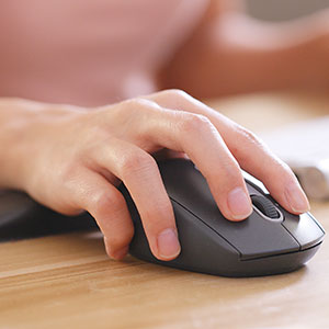 A hand holding a computer mouse