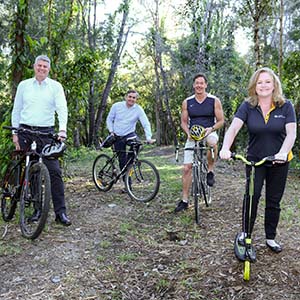 This is a picture of four people at the the location of the future rail trail.