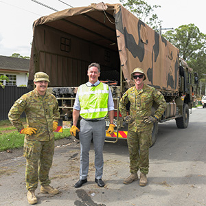 City of Logan Mayor Darren Power and ADF personnel Lt Sam Tenni (left) and Bdr Nathan Sawdy join the flood clean-up in Slacks Creek today.