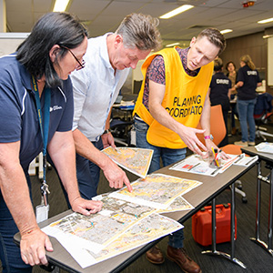 Mayor Darren Power and Infrastructure Chair Cr Teresa Lane check flood modelling at Logan City Council's Disaster Coordination Centre.