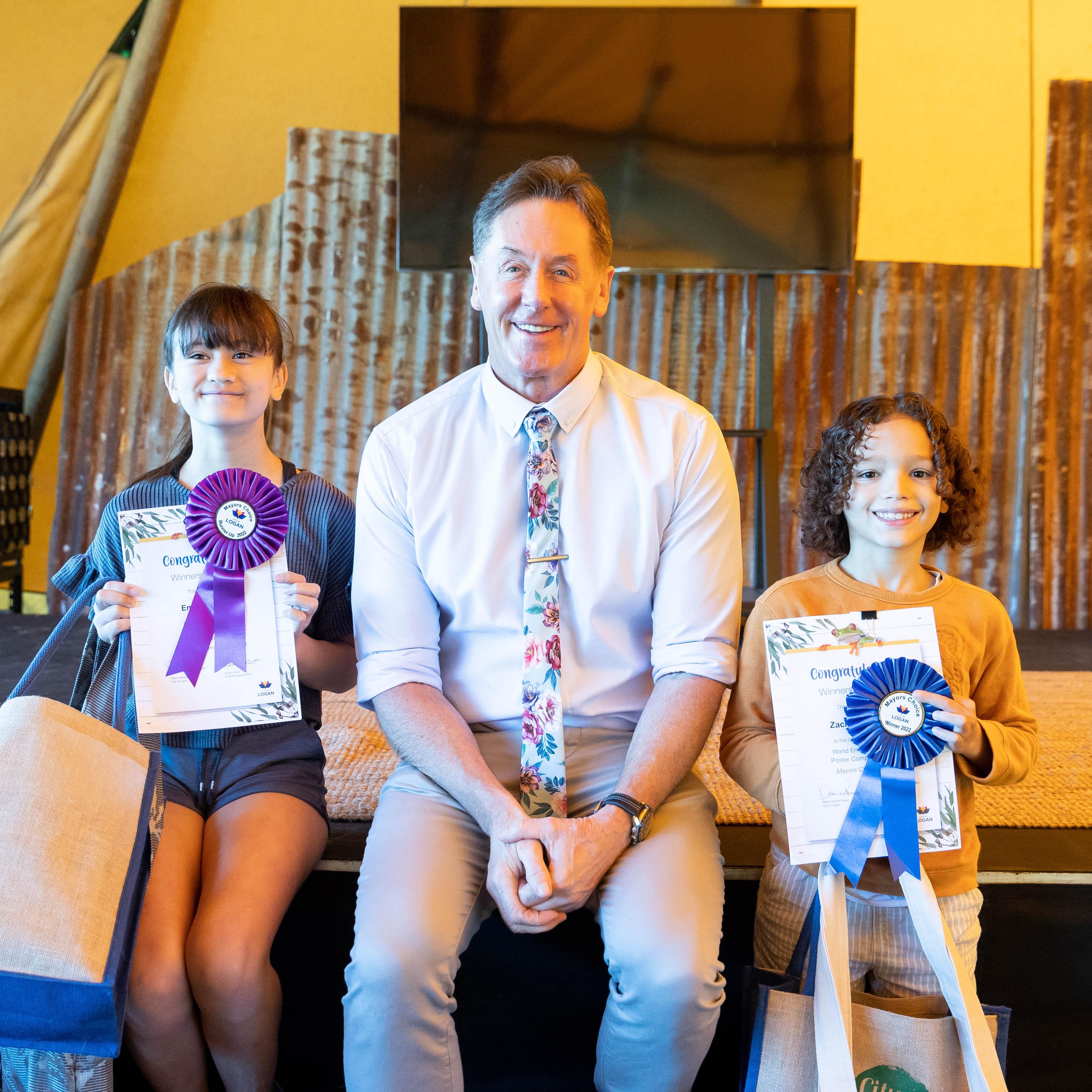 City of Logan Mayor Darren Power with World Environment Day poster competition Mayor's Choice award winners Zachary Jacobs and Emily McIntosh at LEAF on Sunday.