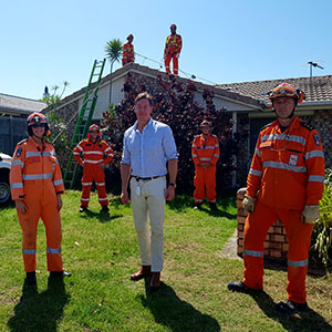 A photograph of Logan Mayor Darren Power with SES workers.