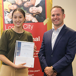 A photograph of Springwood student and Tertiary Educational Bursary recipient Tong Qiu with Deputy Mayor Jon Raven.
