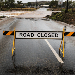 Sign says road closed at flooded roads