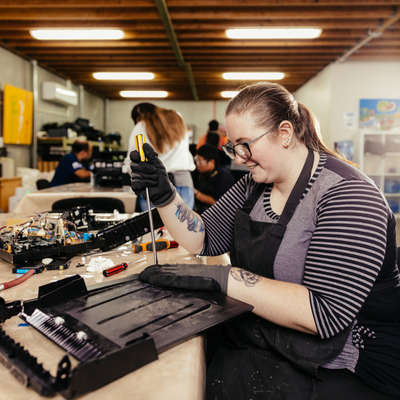 A teenage girl working on a wearable art project.