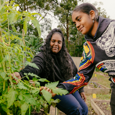 Two girls looking at plants in the garden
