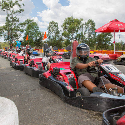 A line up of red go karts on a race track