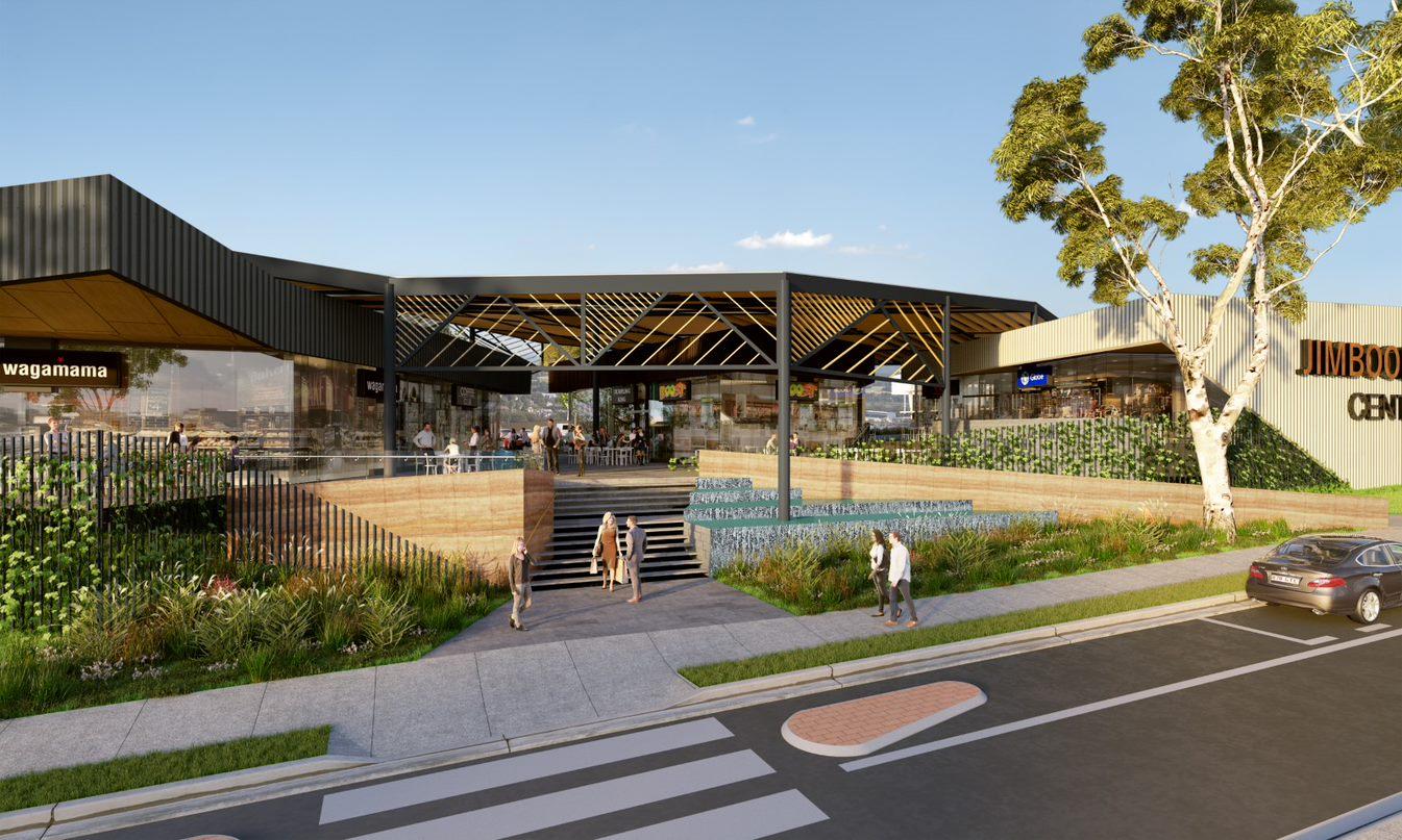 Picture of the redesigned Jimboomba Central shopping centre showing part of the street, footpath and steps leading to to the redesigned shop front.