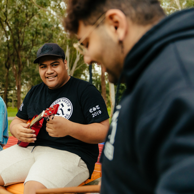 young man playing the ukulele