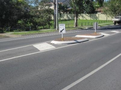 picture of a traffic island refuge in the middle of the road to help cross the road