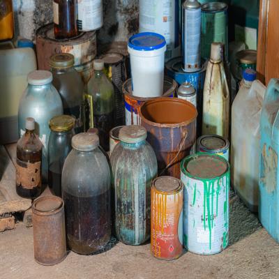 Different chemical and paint containers stored in a garage