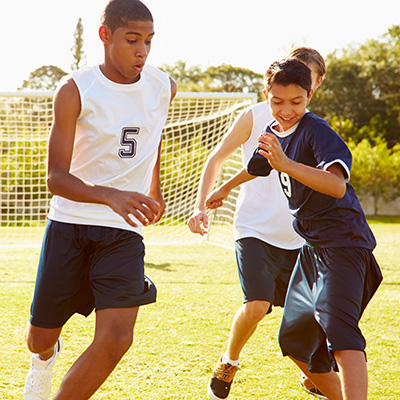 Teens playing soccer