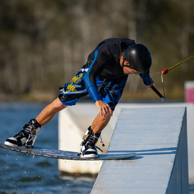 Man wakeboards down a ramp