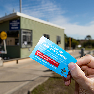 An image of someone holding a waste voucher